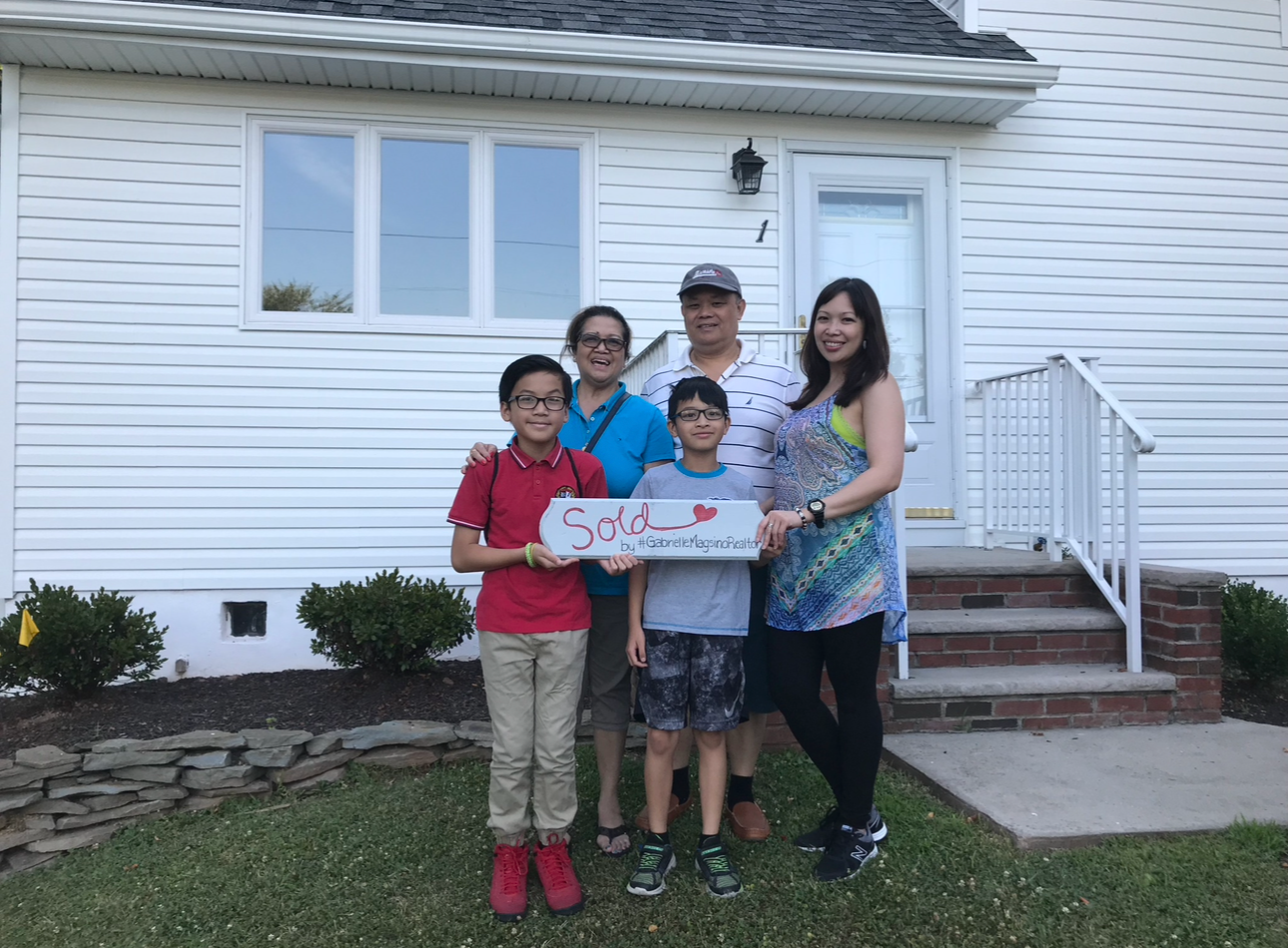 Magsino Group clients with a sold sign at their new home