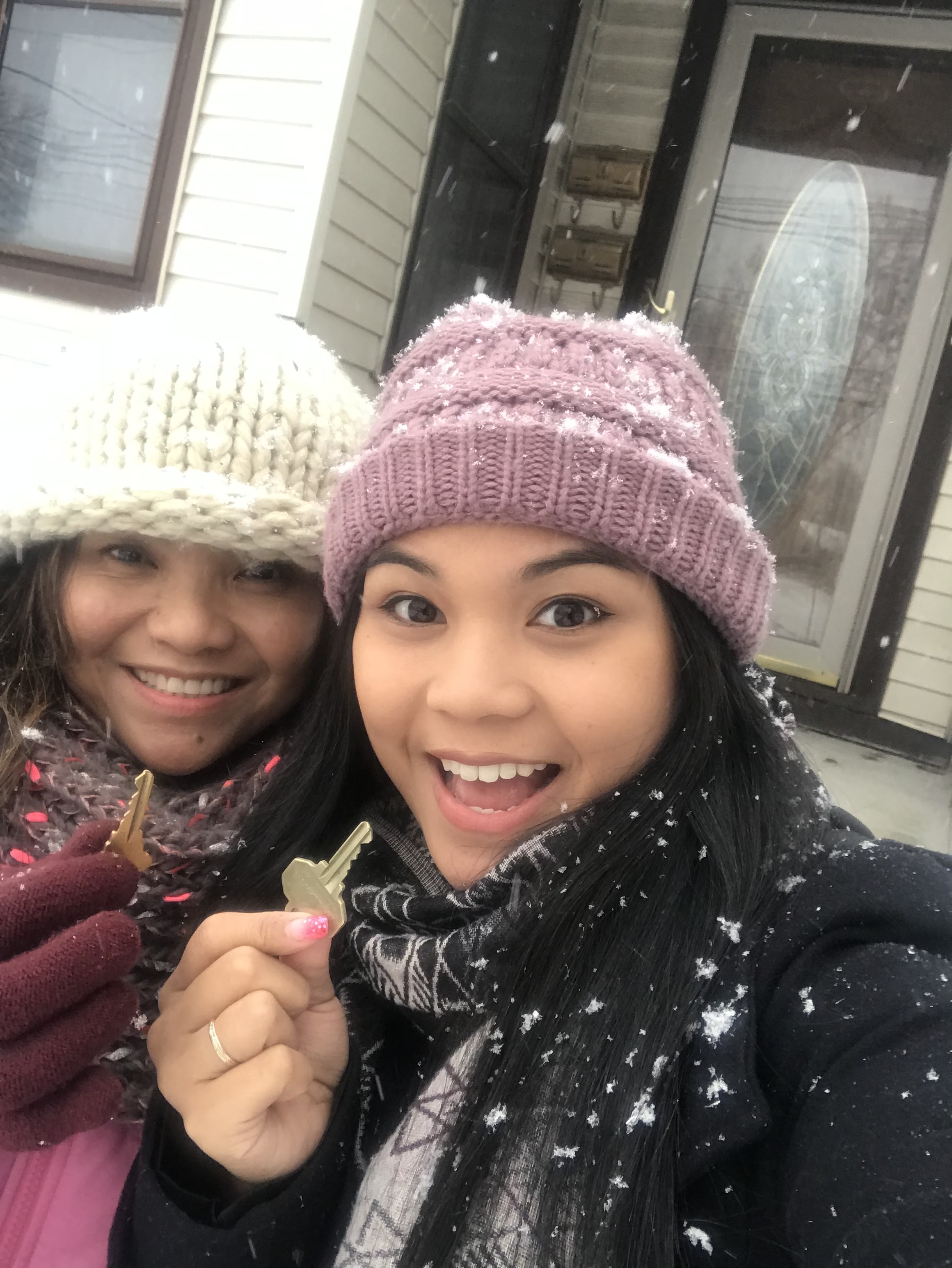 Gabby Magsino handing her mom the keys to her first home